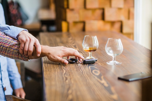 Man avoiding her friend for taking the car keys on table Free Photo