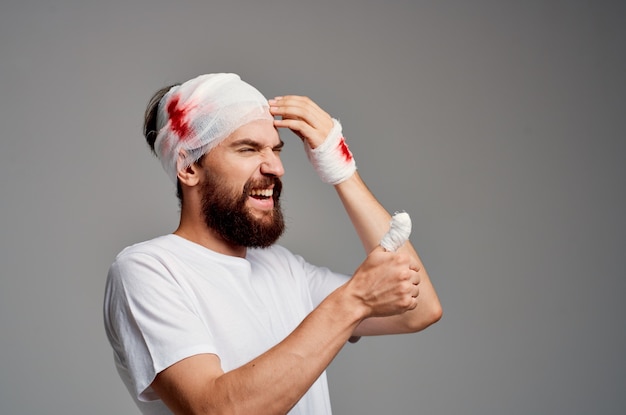 Premium Photo | Man bandaged head and hand blood isolated background