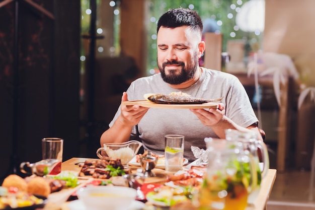 Man at the big table with food. Premium Photo