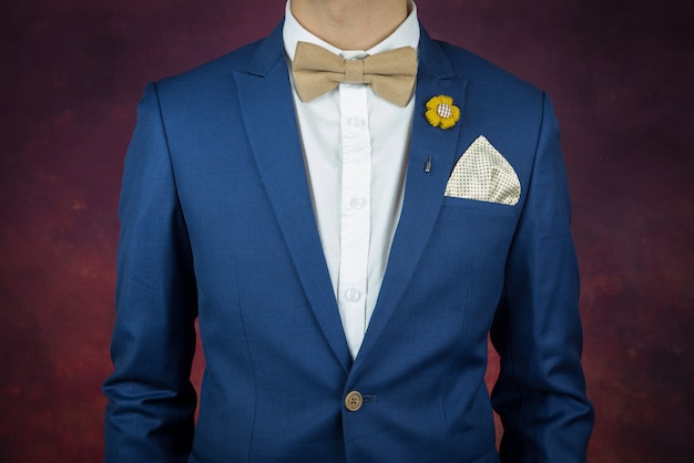 Premium Photo | Man in blue suit bowtie, brooch, handkerchief