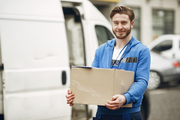 Man by the truck. guy in a delivery uniform. Free Photo