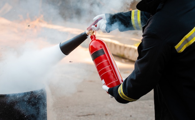 A man conducts exercises with a fire extinguisher. fire extinguishing ...