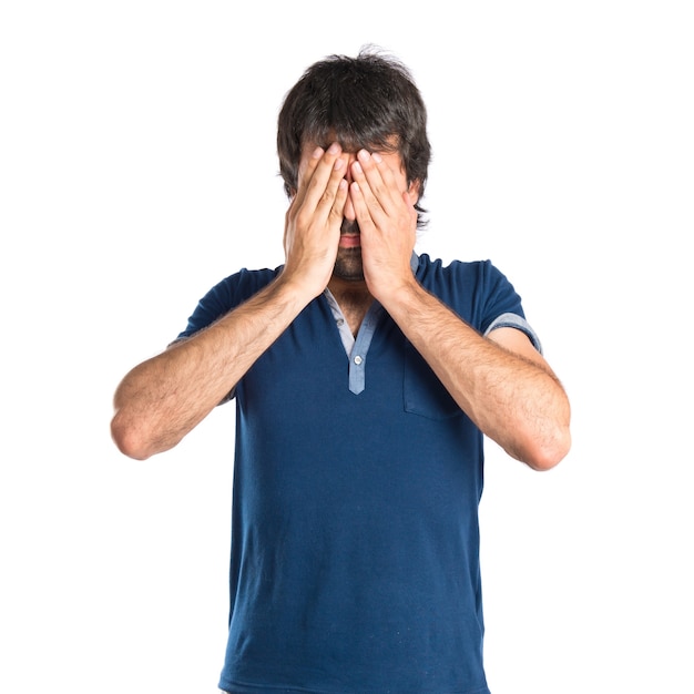 Free Photo | Man covering his eyes over isolated white background