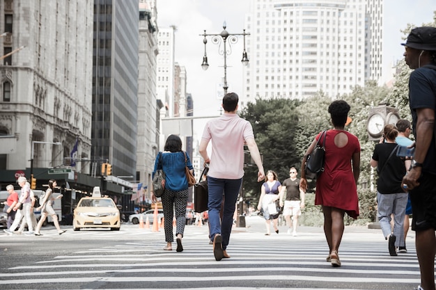 Man crossing road on busy street Photo | Free Download