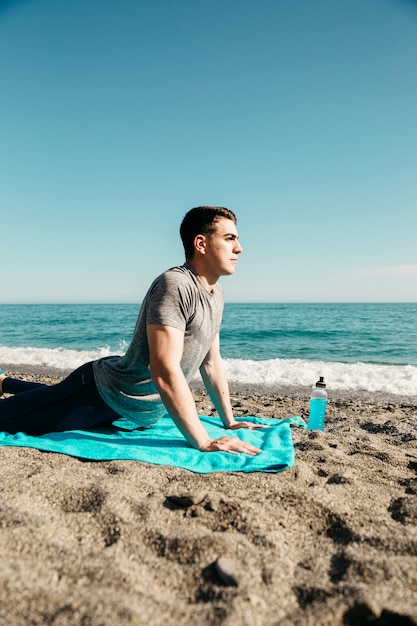 Free Photo Man Doing Yoga At The Beach