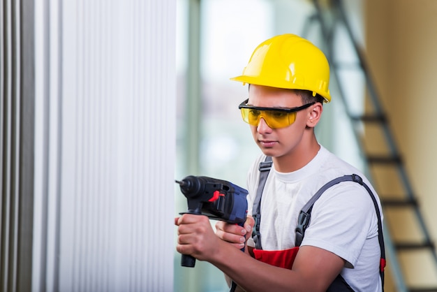 Premium Photo Man Drilling The Wall With Drill Perforator