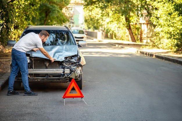 Premium Photo | Man driver looking on smashed broken car ...