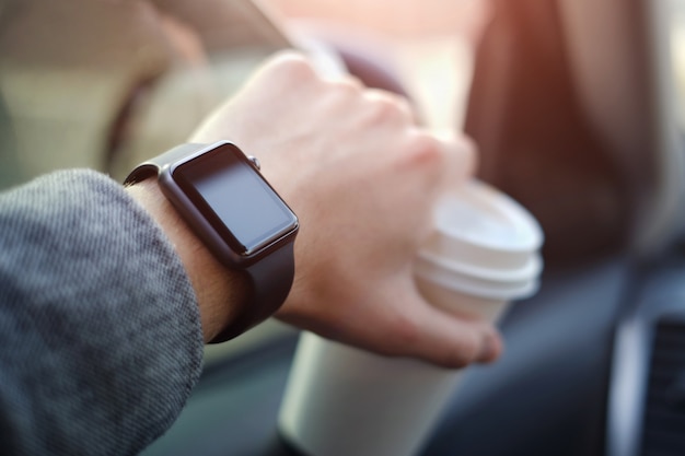 Man driving a car with watch on his hand Premium Photo