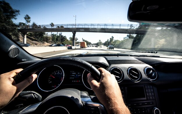 Premium Photo | Man driving muscle car in la