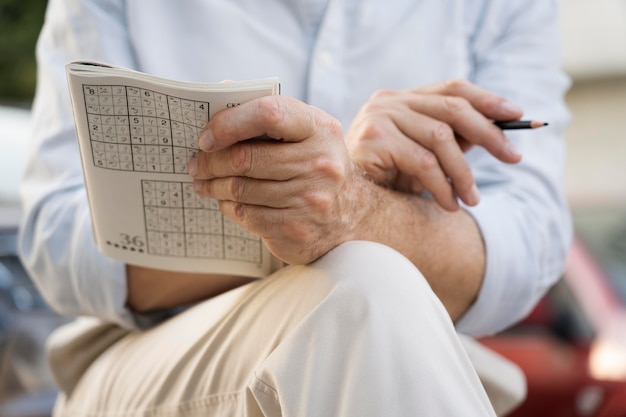 Free Photo | Man enjoying a sudoku game on paper