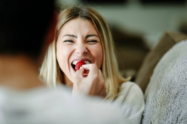 Premium Photo Man Feeding A Strawberry To His Girlfriend