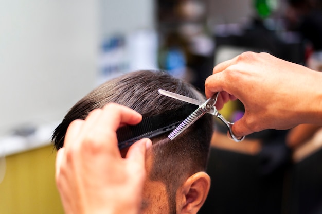 Man Getting A Haircut With Scissors Free Photo