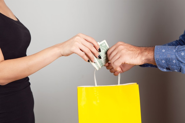 Premium Photo | A man gives a gift bag and a woman pays for it ...