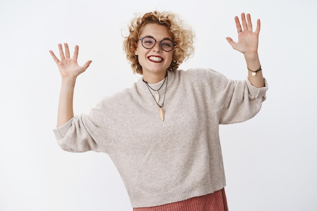 premium-photo-man-in-glasses-and-stylish-warm-sweater-raising-palms-high-and-showing-number