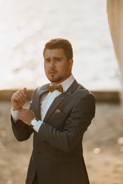 Premium Photo A Man In A Gray Suit Poses On The Street To Advertise Men S Clothing Shooting For Men S Clothing Store