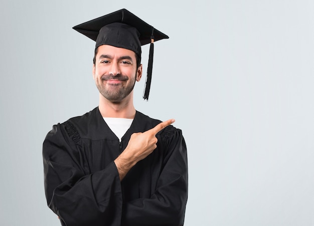 Premium Photo | Man on his graduation day university pointing to the ...