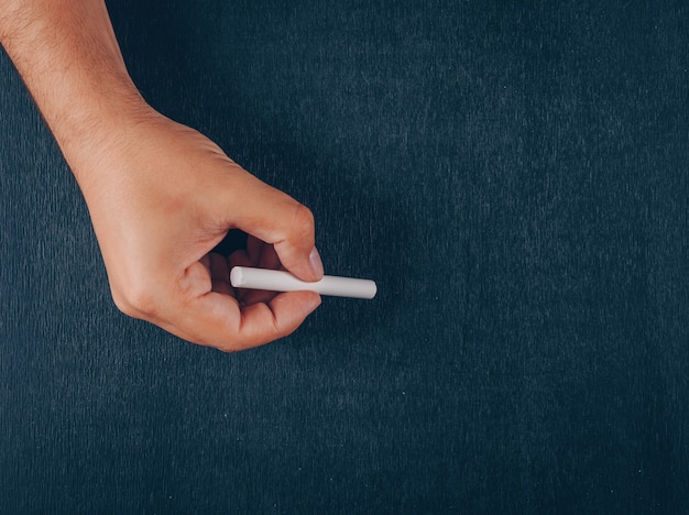 Man Holding Chalk On Black Free Photo