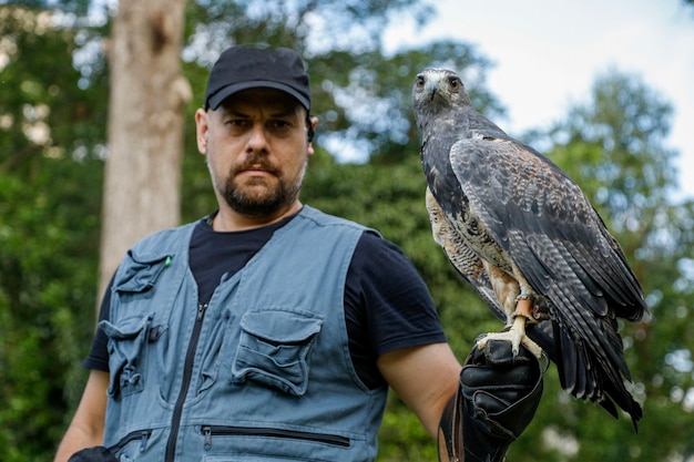 Premium Photo | Man holding an eagle blackchested