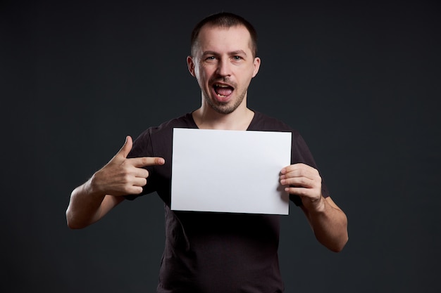 Premium Photo Man Holding An Empty Paper Sheet In His Hands