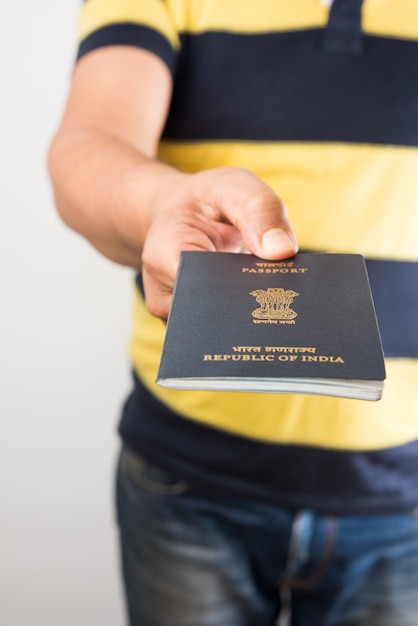 Premium Photo Man Holding Indian Passport Over White Background Selective Focus 2125