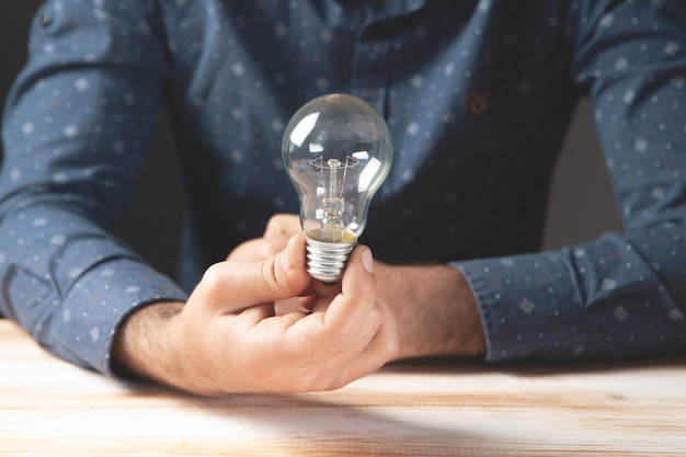 Premium Photo | A man holding a light bulb