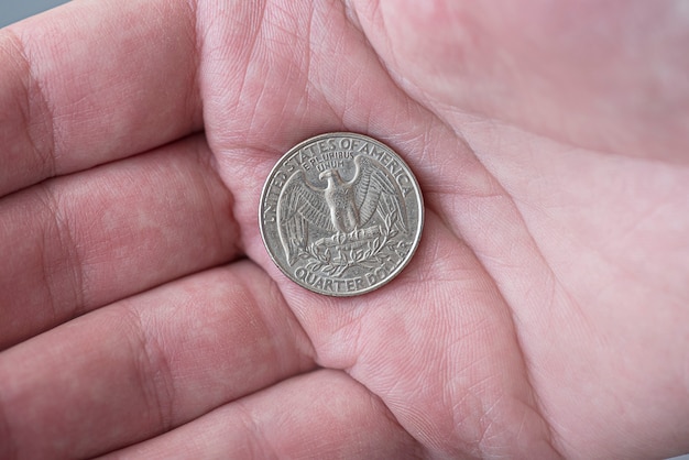 Premium Photo A Man Holding Silver American Quarter Dollar Coin 25 Cents Usa