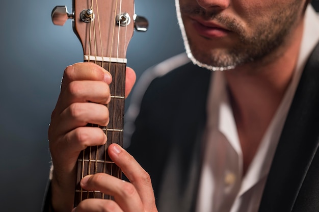 Free Photo Man Holding The Strings Of A Guitar