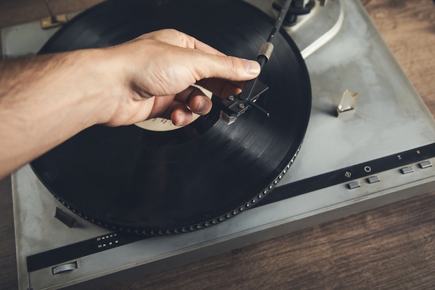 Premium Photo | Man holding vintage record player on table