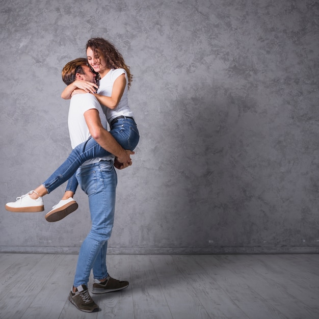 Free Photo Man Holding Woman In Arms 