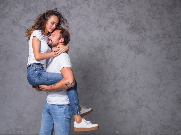 Free Photo Man Holding Young Woman In Arms