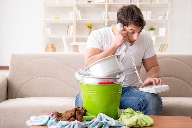 Man at home dealing with neighbor flood leak Premium Photo