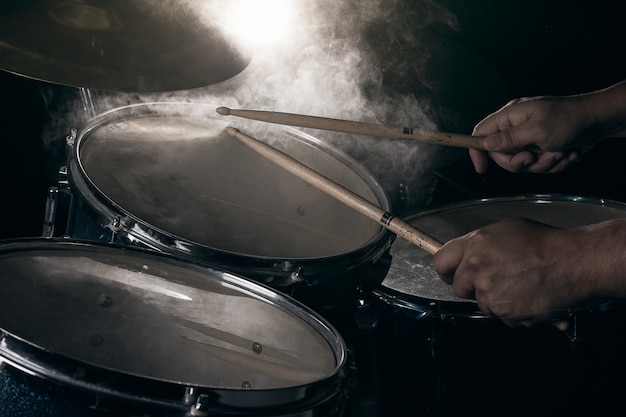 The man is playing drum set. Premium Photo