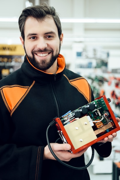 Man is posing with uninterruptible power supply. Premium Photo