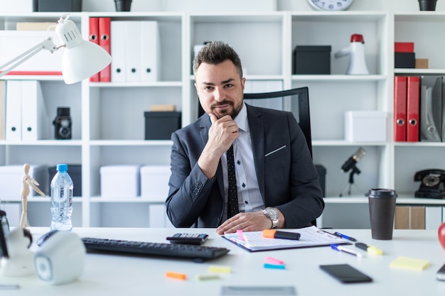 Premium Photo | A man is sitting in a chair in the office at the table