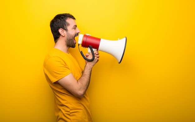 Premium Photo | Man on isolated vibrant yellow color shouting through a ...