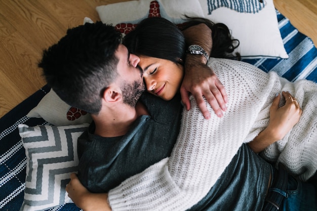 Free Photo Man Kissing To Her Girlfriend On Forehead Lying On