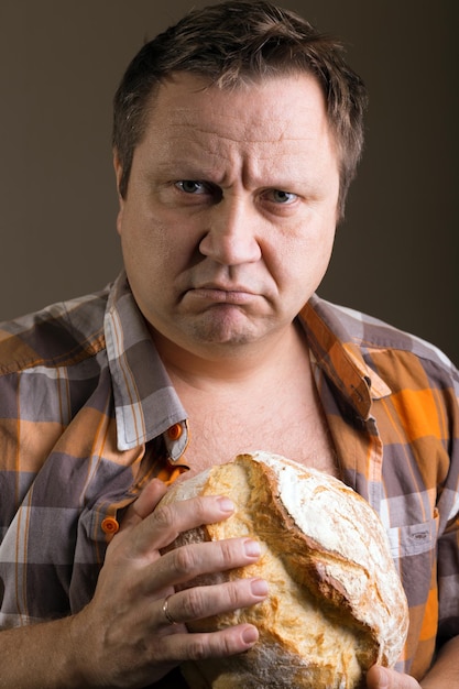 Premium Photo | A man and a loaf of bread. human emotions