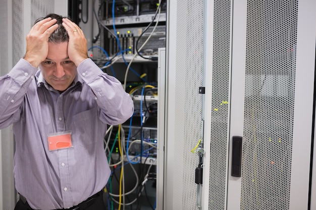 Premium Photo | Man looking weary of data servers