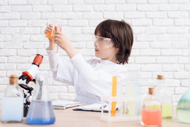 Premium Photo | Man looks at the chemical reactions in the flask