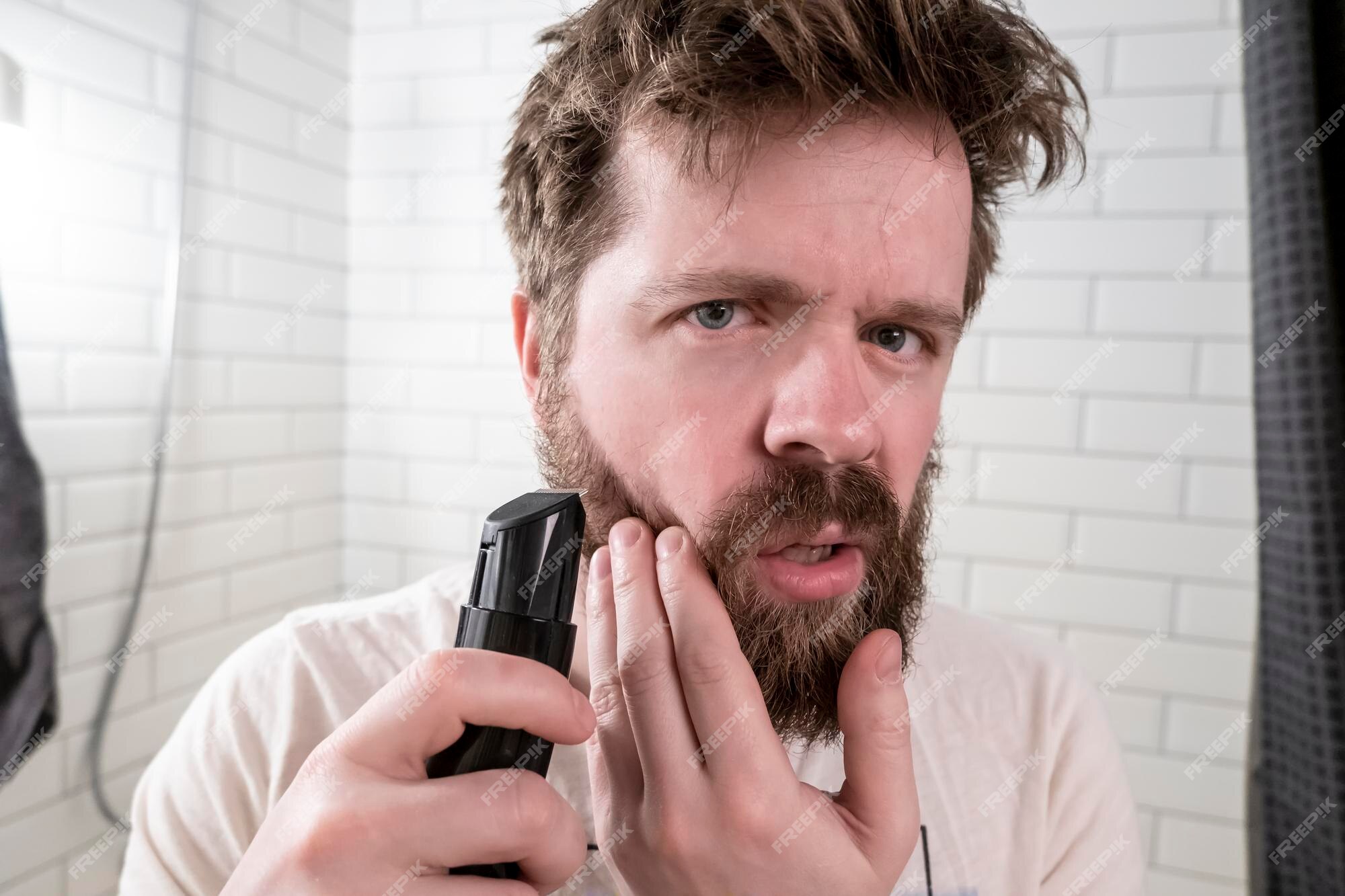 Man Looks Mirror Shaggy Hairstyle Beard Going Make Himself Haircut With Trimmer 262238 2275 ?w=2000