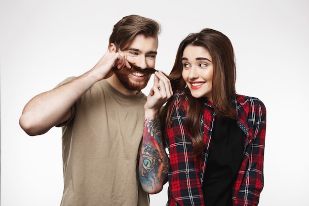 Free Photo Man Making Funny Faces Playing With Girl S Hair On White