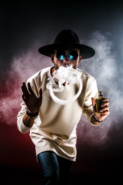 Premium Photo Man  making smoke ring with vape 