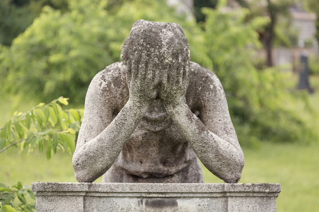 man-monument-with-hands-his-head-tomb-graveyard_136401-430.jpg