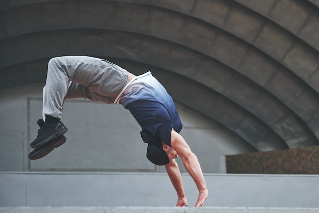 Free Photo | The man outdoors practices parkour, extreme acrobatics.