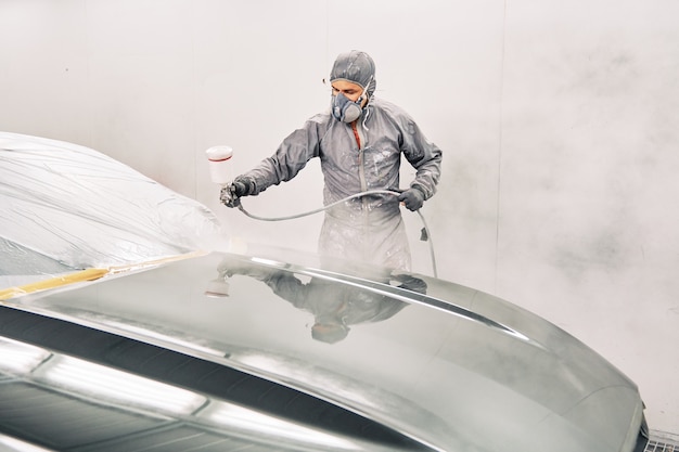 A man painting a car | Premium Photo