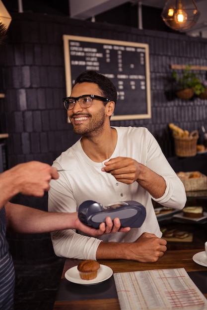 premium-photo-man-paying-his-bill-with-credit-card