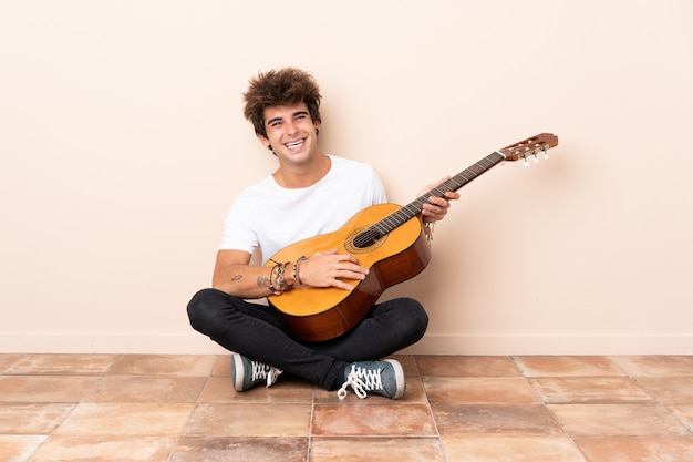 Man Playing The Guitar And Sitting On The Floor Photo Premium Download   Man Playing Guitar Sitting Floor 1368 72532 