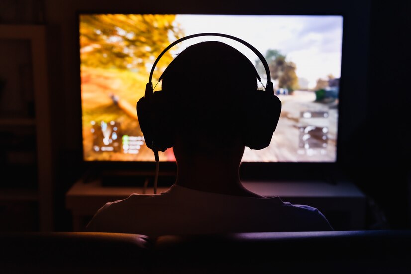 Premium Photo | Man playing the video game at night