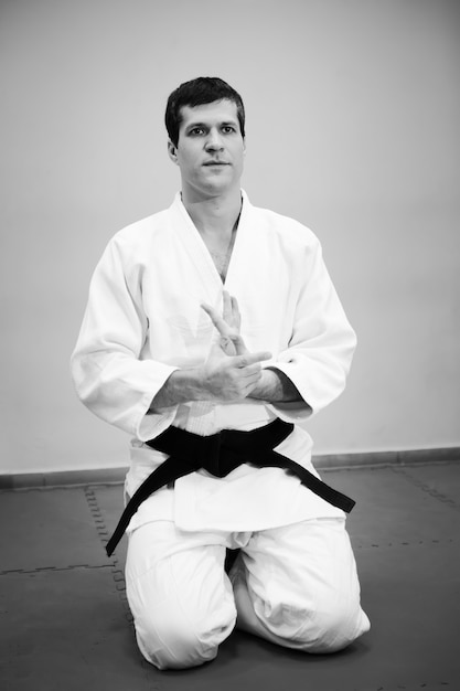 Premium Photo | Man practicing aikido in a sport jum