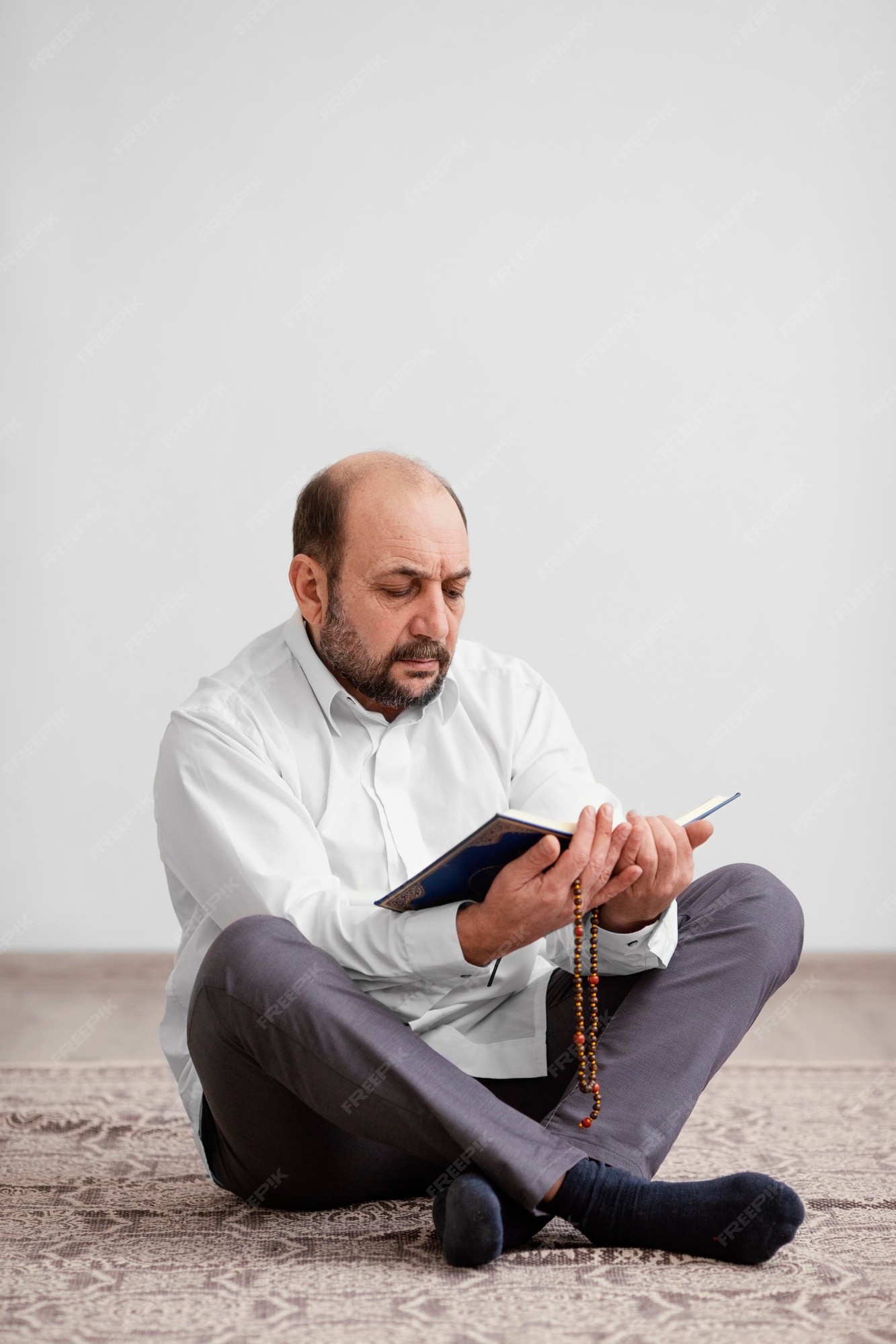 Free Photo | Man praying on the floor indoors